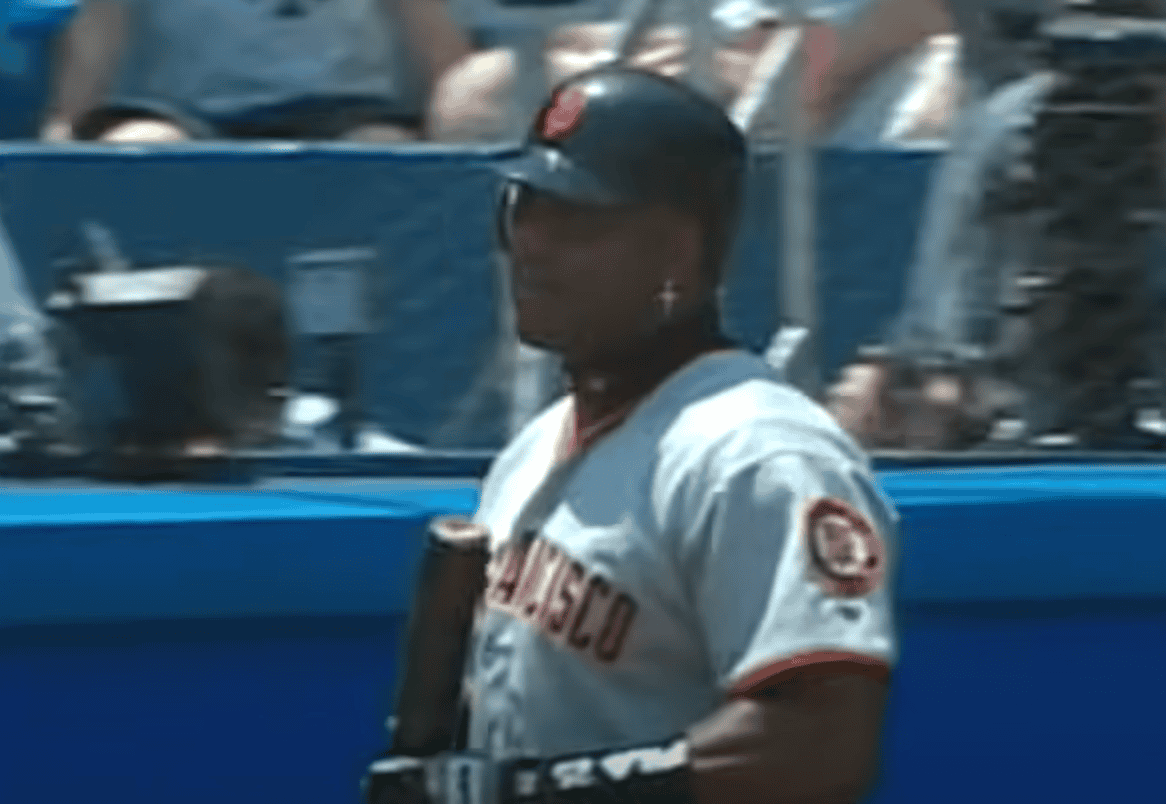 Barry Bonds hitting a home run, showcasing his legendary left field prowess.